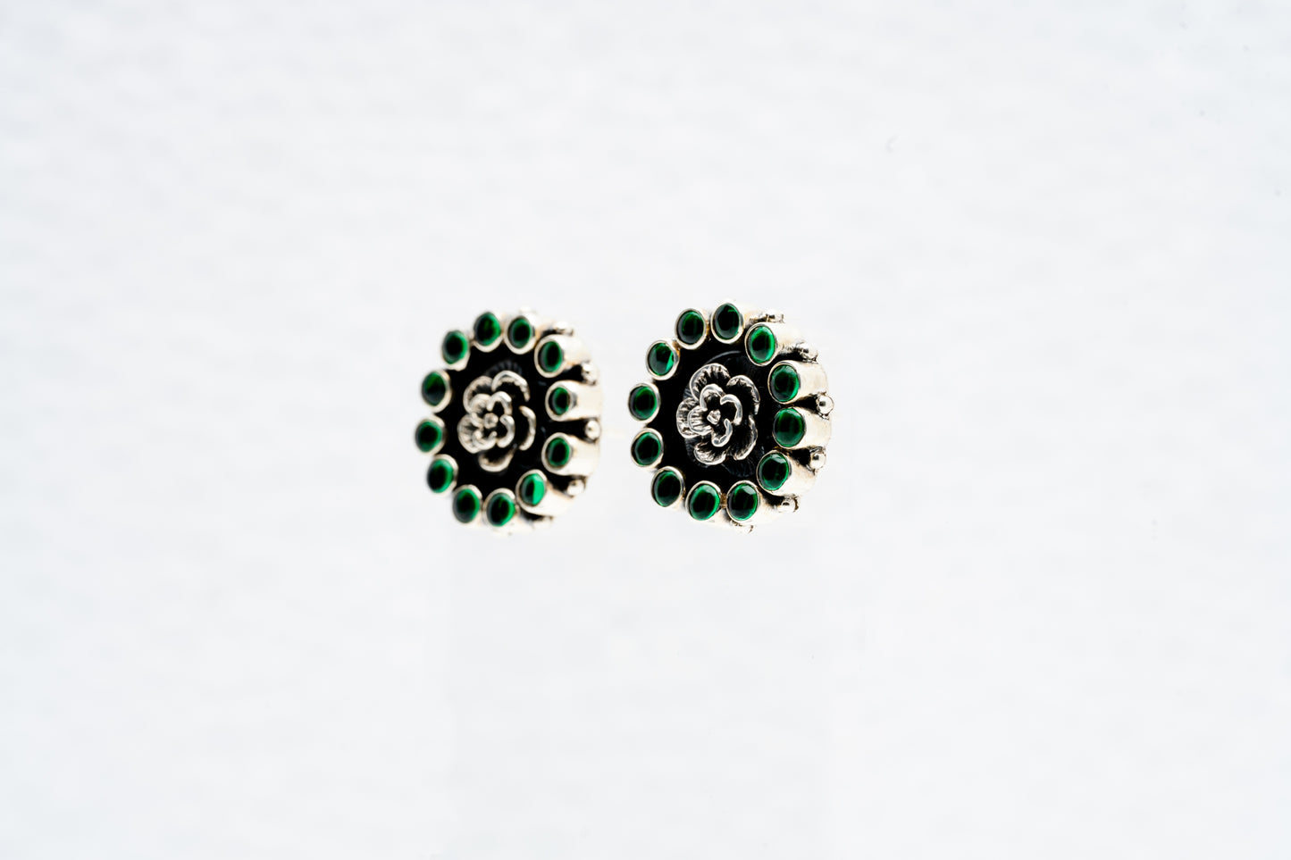 Floral silver earrings with green stone